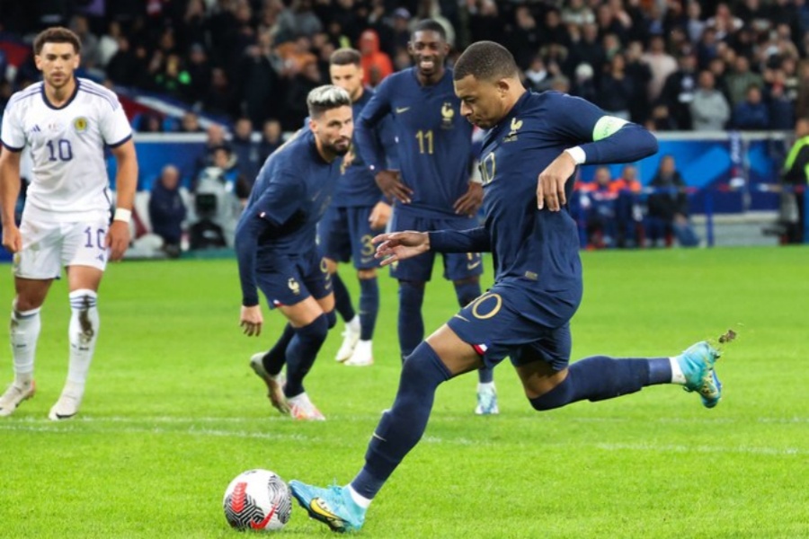 France's forward  Kylian Mbappe shoots and scores his team's third goal on a penalty during the friendly football match between France and Scotland at Pierre-Mauroy stadium, in Villeneuve-D'Ascq, northern France, on Tuesday. (AFP)